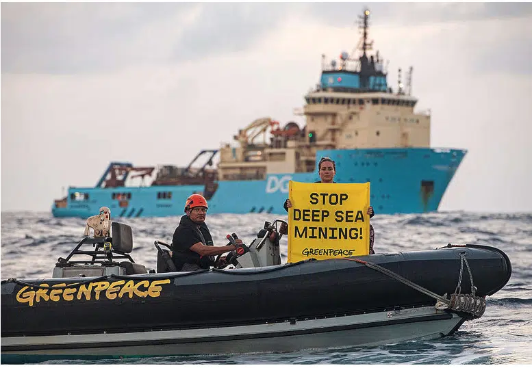 Greenpeace International activist Alice, displays a banner reading “Stop Deep Sea Mining” in front of the Maersk Launcher, a ship chartered by DeepGreen, one of the companies spearheading the drive to mine the barely understood deep sea ecosystem