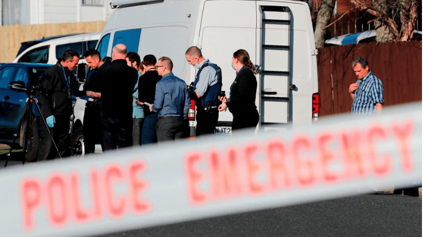 New Zealand police investigators work in Auckland on August 11, 2022, after human remains were discovered in suitcases.