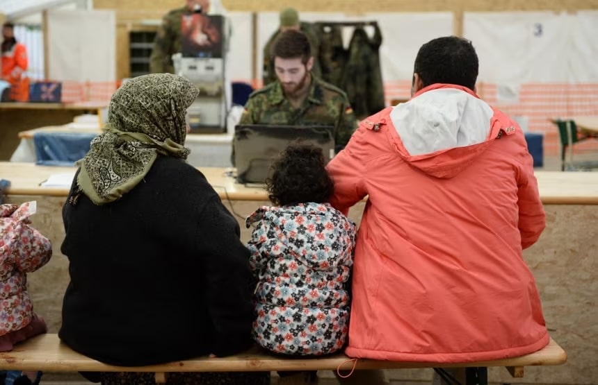 Refugees from Syria wait to register at the German army's air base in Erding, southern Germany
