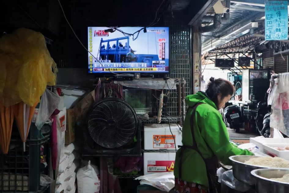 A woman works in a noodle store near a television screen showing a news report on China's Justice Mission 2025 military drills around Taiwan, in Taipei, Taiwan on Monday.