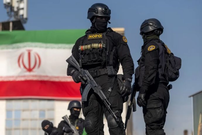 Iranian security forces keep watch during a pro-government rally held in Tehran on Monday.