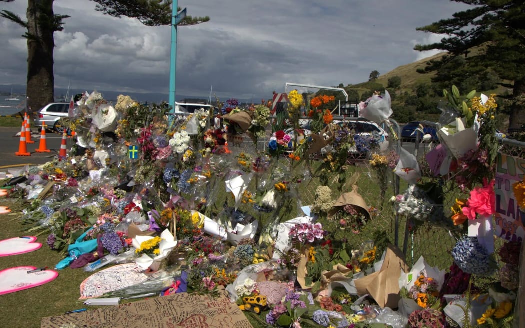 Bouquets and tributes at the Mount Maunganui landslide cordon.
