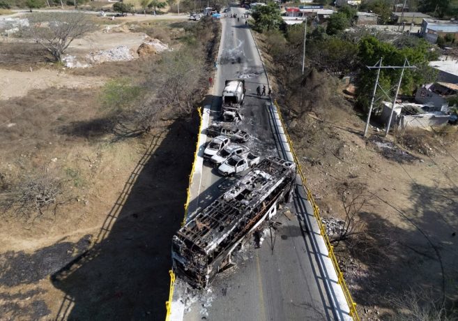 Burned vehicles over the "La Desembocada" bridge in Puerto Vallarta, Jalisco state, on February 24, following violence spurred by the capture and death of Mexico's most-wanted drug lord.