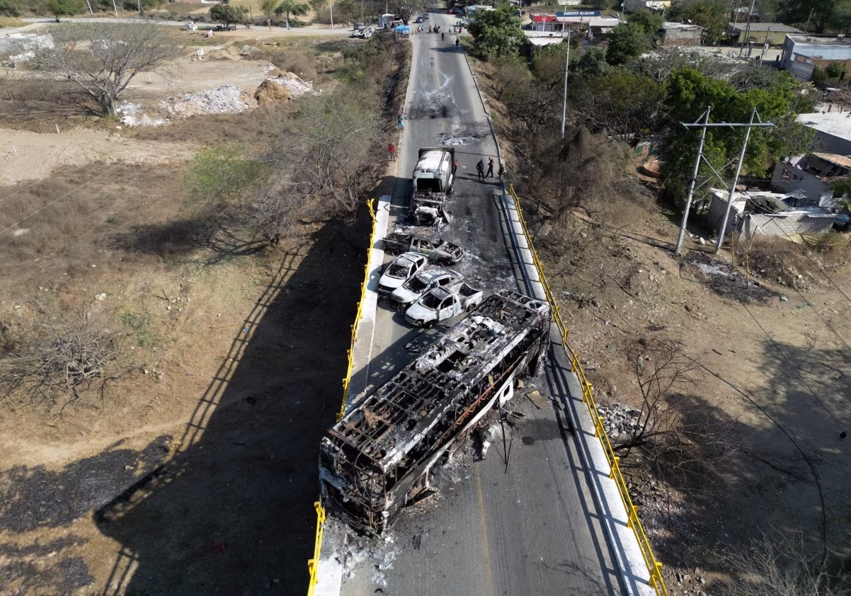 Burned vehicles over the "La Desembocada" bridge in Puerto Vallarta, Jalisco state, on February 24, following violence spurred by the capture and death of Mexico's most-wanted drug lord.