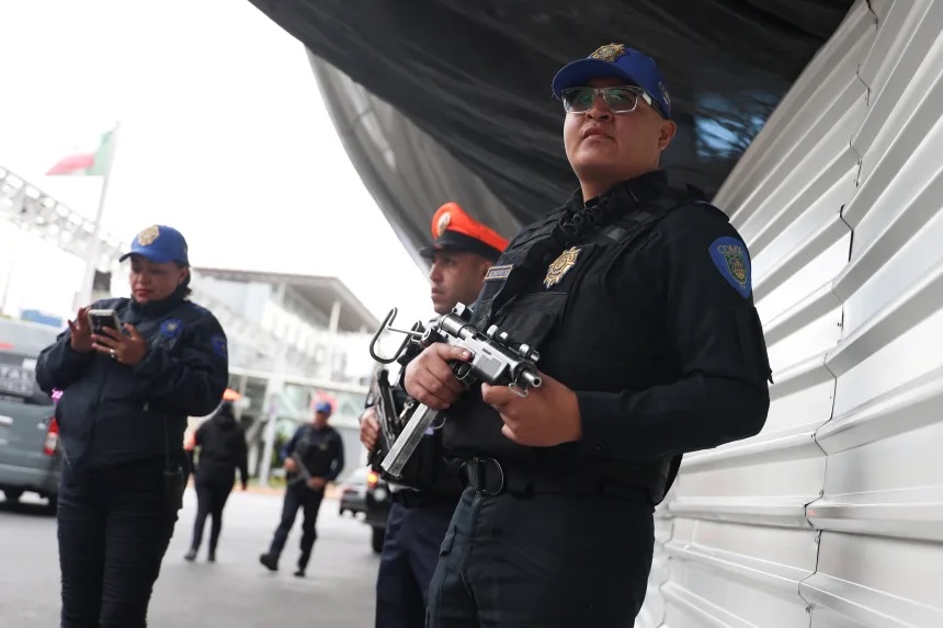 Police officers patrol Benito Juarez International Airport following roadblocks and arson attacks after a military operation in Jalisco state, in Mexico City, Mexico, on February 22, 2026.