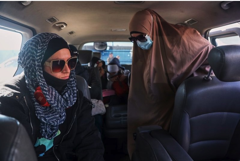 Family members of suspected Islamic State militants who are Australian nationals board a van heading to the airport in Damascus during the first repatriation operation of the year, at Roj Camp in eastern Syria, on Monday, February 16, 2026