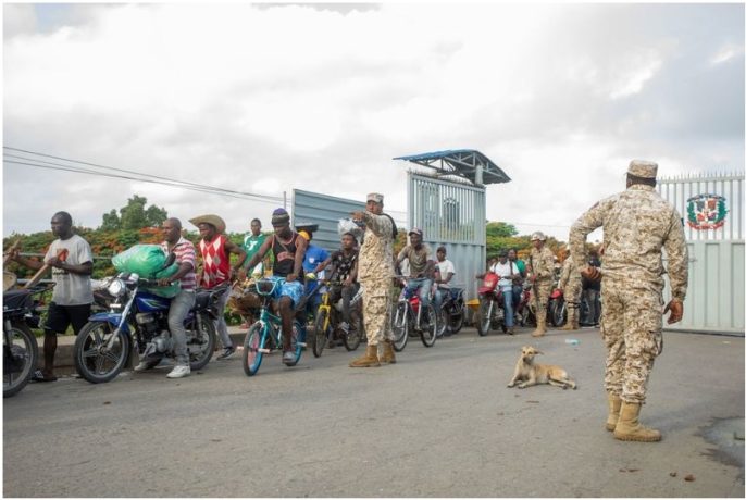 Members of the Dominican Republic's Specialised Border Security Corps direct pedestrians arriving from Haiti at the Dajabon and Ouanaminthe border bridge in 2022.