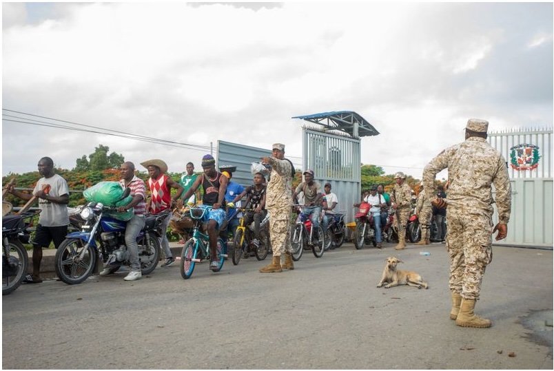 Members of the Dominican Republic's Specialised Border Security Corps direct pedestrians arriving from Haiti at the Dajabon and Ouanaminthe border bridge in 2022.