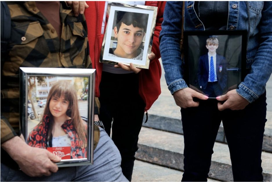 Parents hold images of children who have died after incidents of alleged bullying and blackmail occurred online, outside of the Los Angeles Superior Court.