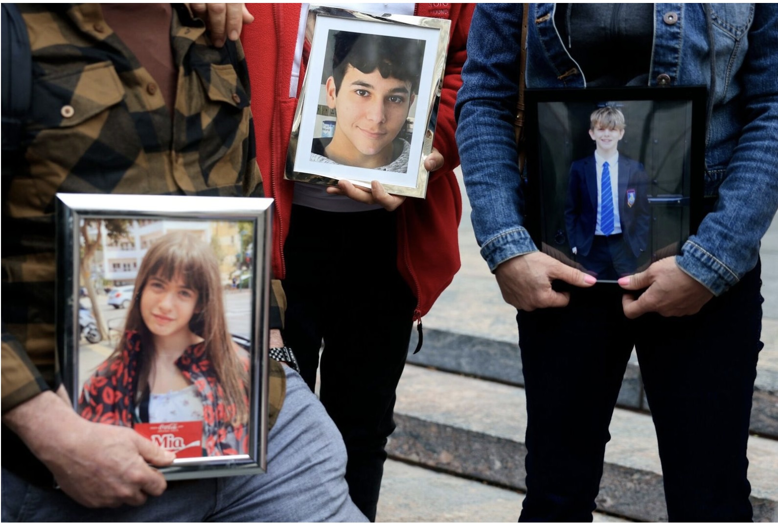 Parents hold images of children who have died after incidents of alleged bullying and blackmail occurred online, outside of the Los Angeles Superior Court.