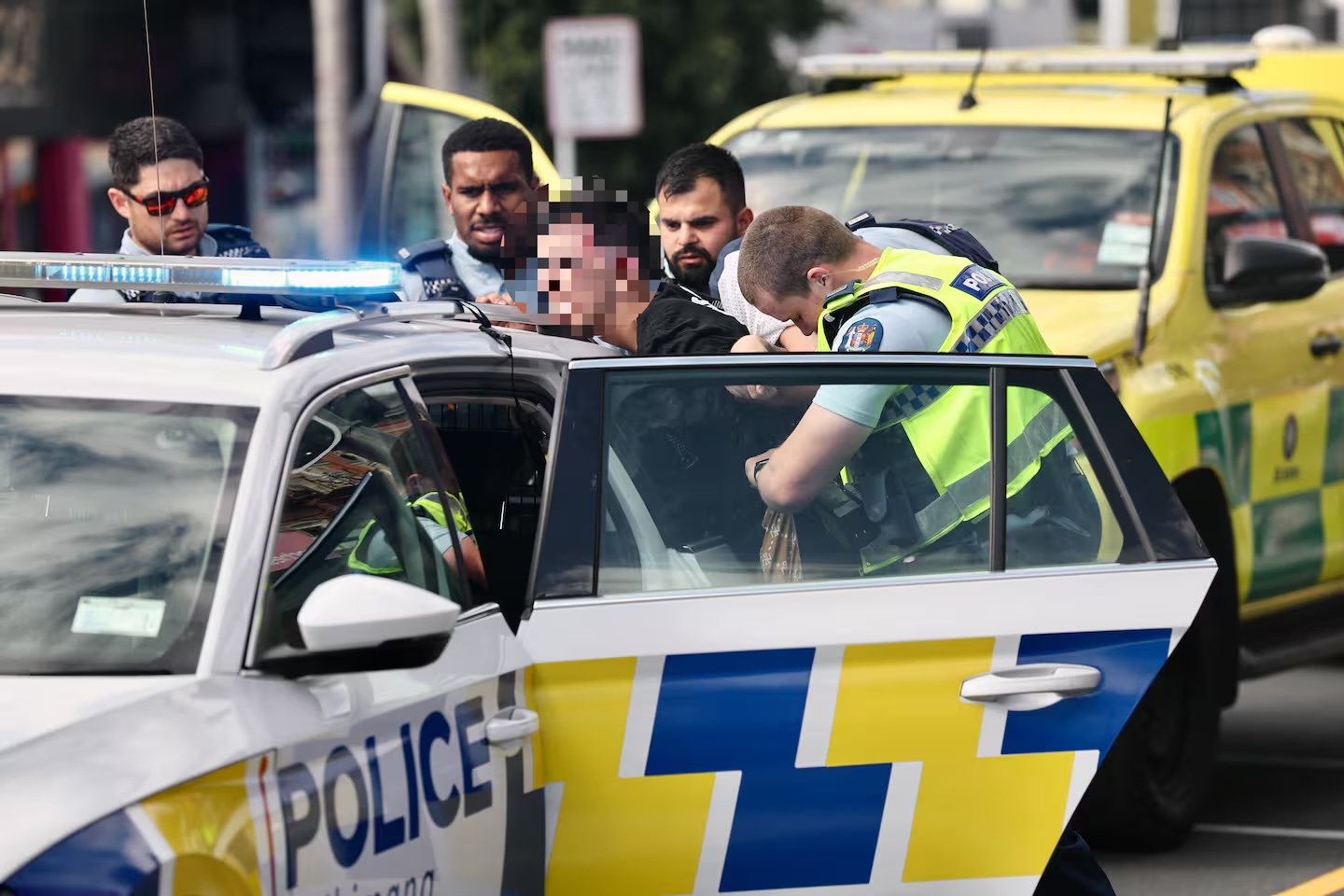 A man is handcuffed in the city.