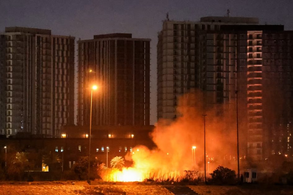 A fire burns outside the grounds of the US Embassy headquarters in Baghdad's fortified Green Zone following a drone and rocket attack on Tuesday night.