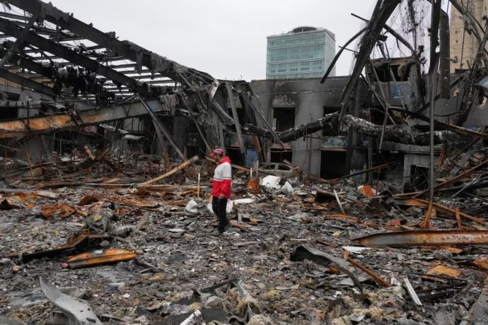 A member of the Iranian Red Crescent Society stands at Hypercar, an auto service center, amid damages which according to the company's officials were caused by strikes on March 1, in Tehran, Iran on March 28, 2026.