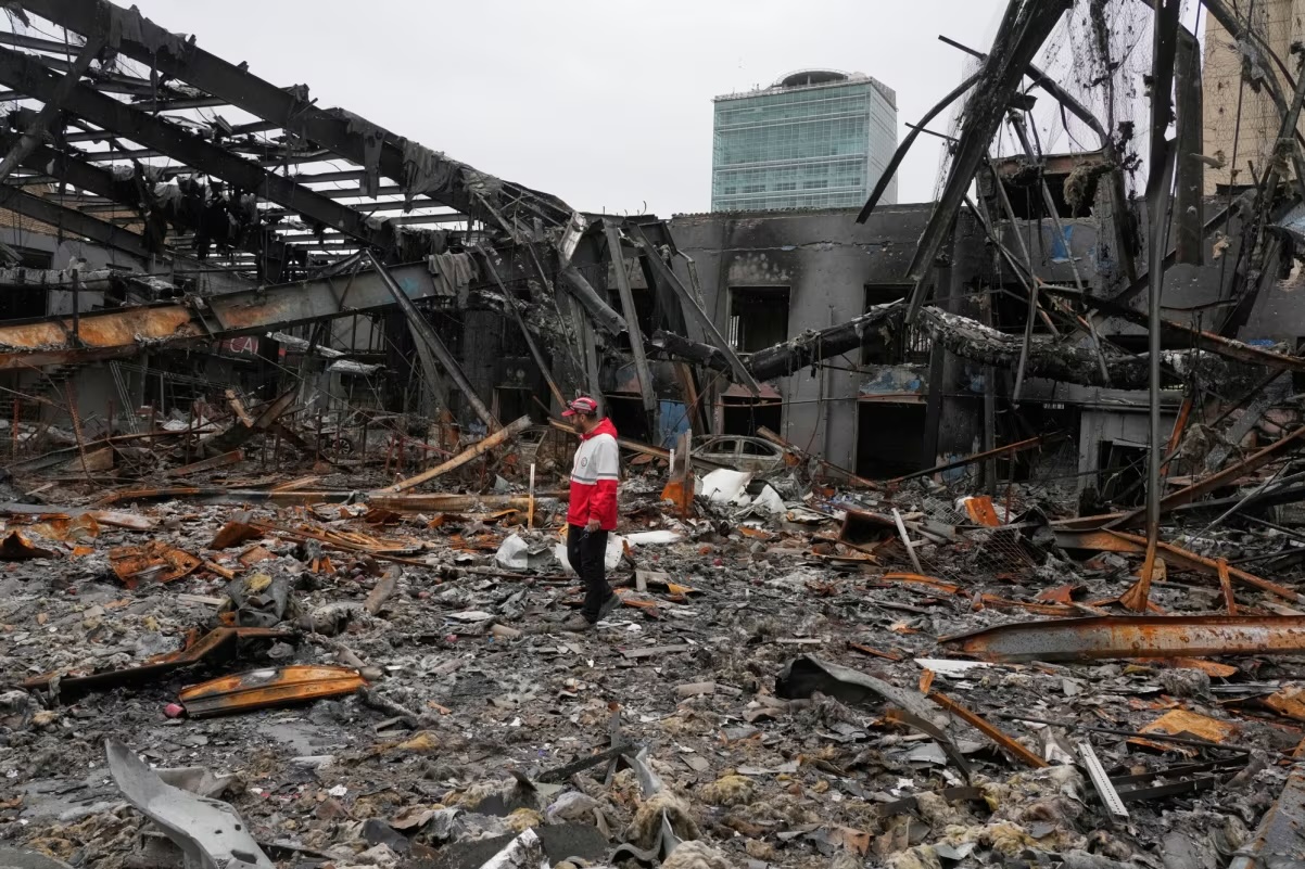 A member of the Iranian Red Crescent Society stands at Hypercar, an auto service center, amid damages which according to the company's officials were caused by strikes on March 1, in Tehran, Iran on March 28, 2026.