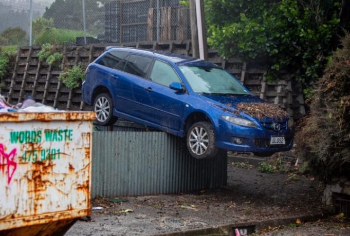 A-car-carried-by-floodwaters-landed-on-top-of-a-chest-high-fence-after-Mondays-torrential-rain-in-Wellington