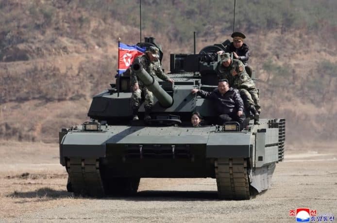 North Korean leader Kim Jong Un and his daughter Kim Ju Ae ride a tank during what North Korean state news agency KCNA reports is an offensive tactical drill involving a new type of tank, at a training base in Pyongyang, North Korea, March 19, 2026, in this picture released by North Korea's official Korean Central News Agency.