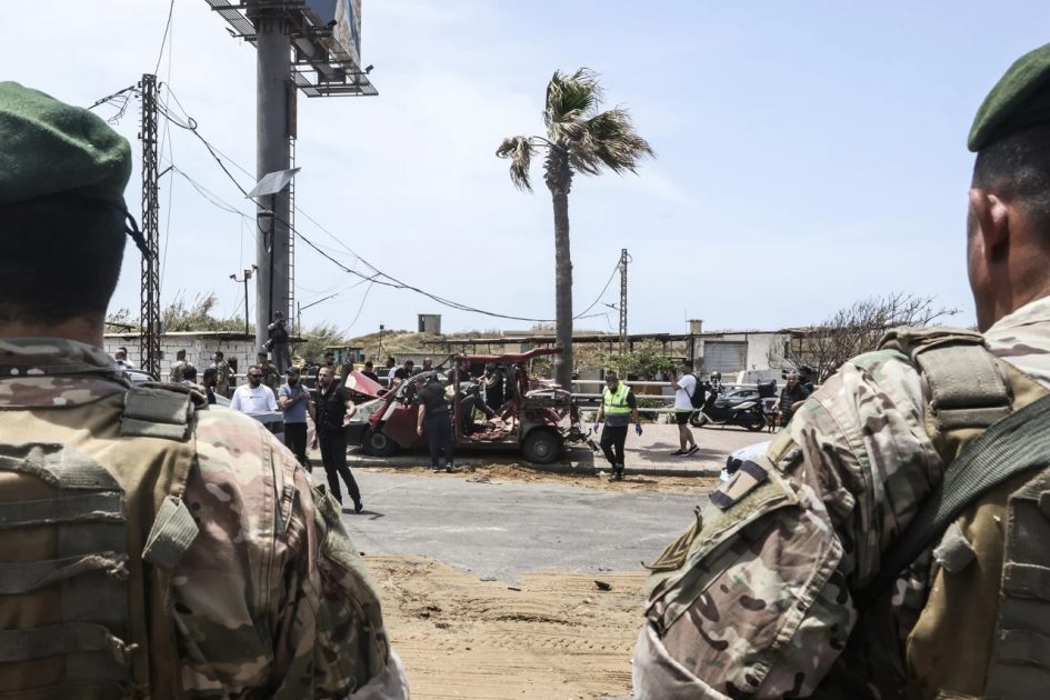 Security forces stand guard as first responders intervene on a vehicle targeted by an Israeli drone strike at the entrance to the southern city of Sidon on Wednesday, May 13. Israeli strikes targeting cars on a highway south of Beirut on May 13 killed eight people, including two children, Lebanon's health ministry said, in the latest attacks despite a ceasefire in the Israel-Hezbollah war.