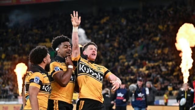 Hurricanes players from left, Winger Fehi Fineanganofo, No.8 Peter Lakai and halfback Cam Roigard celebrate after a lightning-fast start against the Blues. Roigard's early try helped spark Wellington's charge into the Super Rugby Pacific Grand Final.