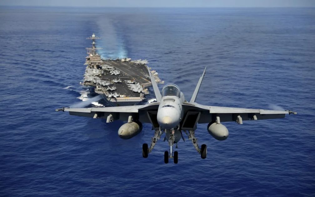 An F:A-18E Super Hornet participates in an air power demonstration over the aircraft carrier USS John C. Stennis.