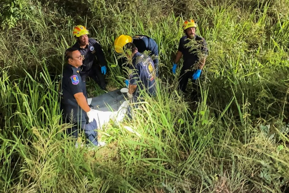 Rescue workers recover a suitcase from a grassy area near a railway track, in which police later found the body of a 17-year-old Thai girl, in Pattaya City, Thailand, on June 27, 2026.