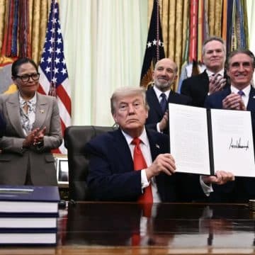 US President Donald Trump displays a proclamation on "returning American commercial fishing in the Pacific" in the Oval Office of the White House in Washington, DC, on 11 June 2026.