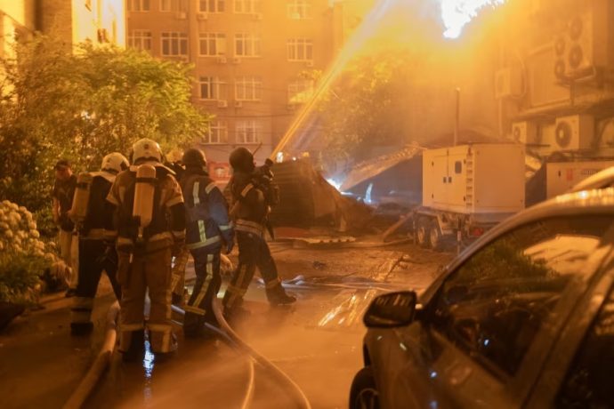 Ukrainian firefighters battle a fire in a building hit by a drone during a Russian air attack on Kyiv, early on July 2, 2026.