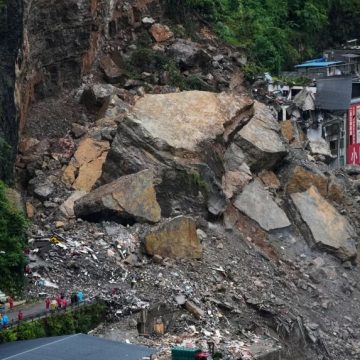 Rescuers stand by to conduct a search and rescue operation at the scene of a landslide in southwestern China's Chongqing city on July 18, 2026.