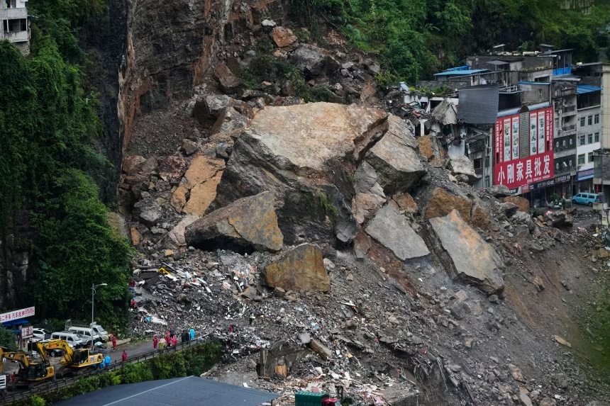 Rescuers stand by to conduct a search and rescue operation at the scene of a landslide in southwestern China's Chongqing city on July 18, 2026.