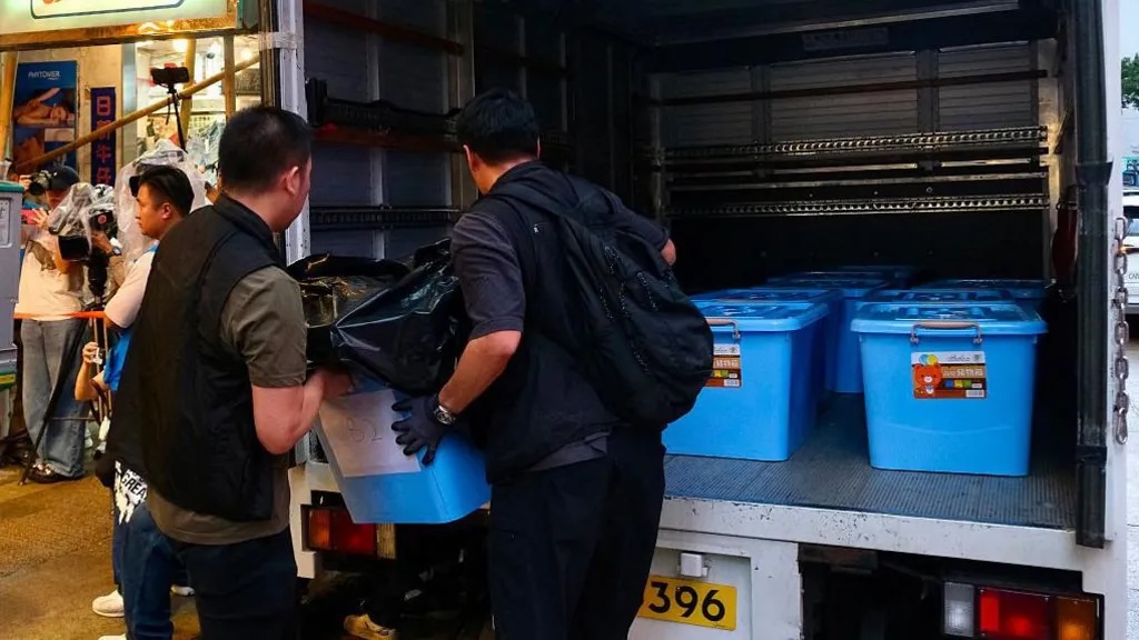 Officers were seen loading confiscated items into the back of a van.