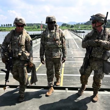 US soldiers walk on a floating bridge during a South Korea-US joint river-crossing drill as part of the annual Ulchi Freedom Shield military exercise in Yeoju on August 27, 2025.