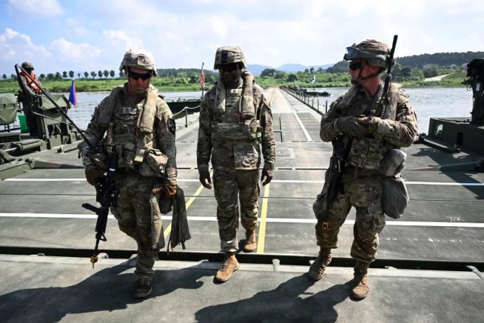 US soldiers walk on a floating bridge during a South Korea-US joint river-crossing drill as part of the annual Ulchi Freedom Shield military exercise in Yeoju on August 27, 2025.