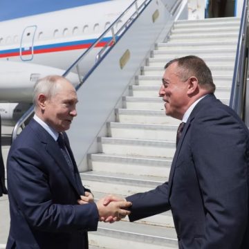 Russian President Vladimir Putin shakes hands with Sakhalin Region Governor Valery Limarenko at an airport in Kurilsk during a visit to the Kuril Islands on Thursday.