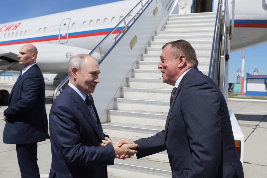 Russian President Vladimir Putin shakes hands with Sakhalin Region Governor Valery Limarenko at an airport in Kurilsk during a visit to the Kuril Islands on Thursday.