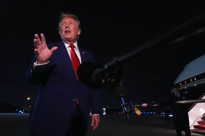 President Donald Trump talks to reporters after arriving on Air Force One Tuesday, August 11, at Joint Base Andrews, Maryland.