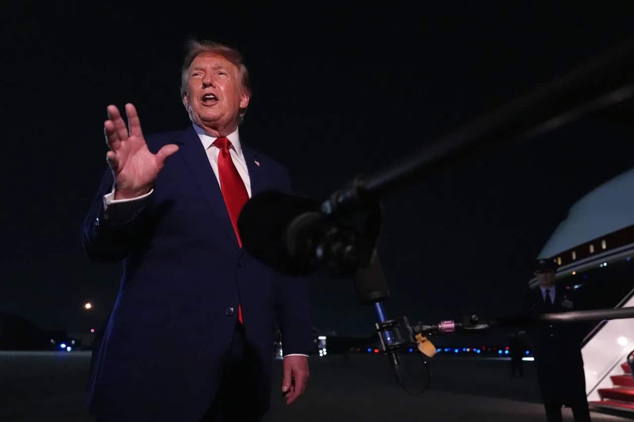 President Donald Trump talks to reporters after arriving on Air Force One Tuesday, August 11, at Joint Base Andrews, Maryland.